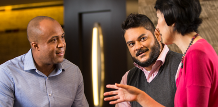 Three Lilly employees discussing latest developments at Lilly