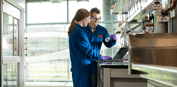 Two Lilly employees in a lab checking quarterly results