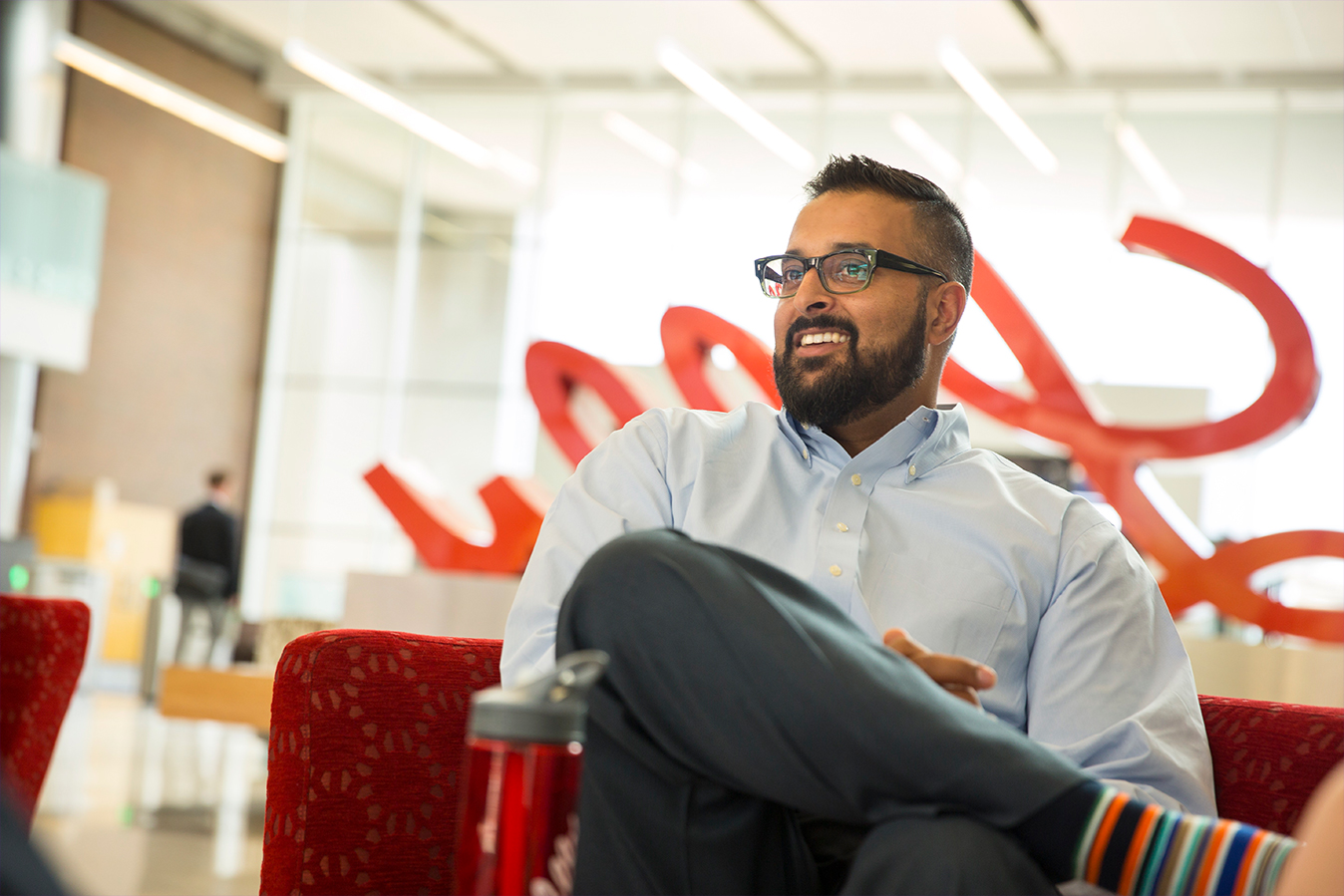 Lilly employee smiling while sitting in the Lilly Corporate Center