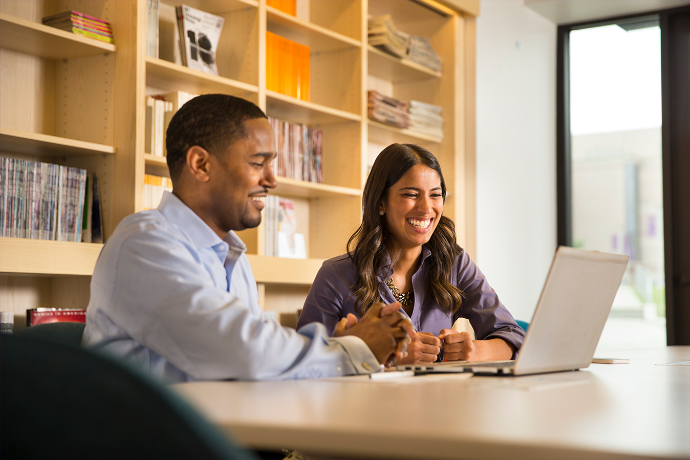 Two Lilly employees collaborating on a project in the Lilly Library located at the Lilly Corporate Center in Indianapolis, Indiana