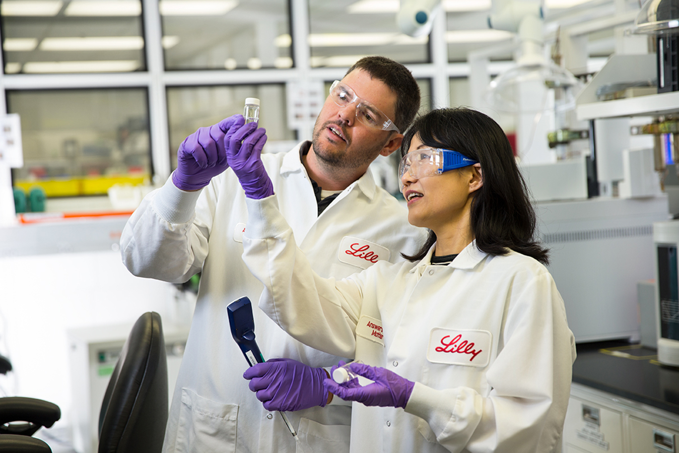 Two Lilly scientists working in the lab checking results